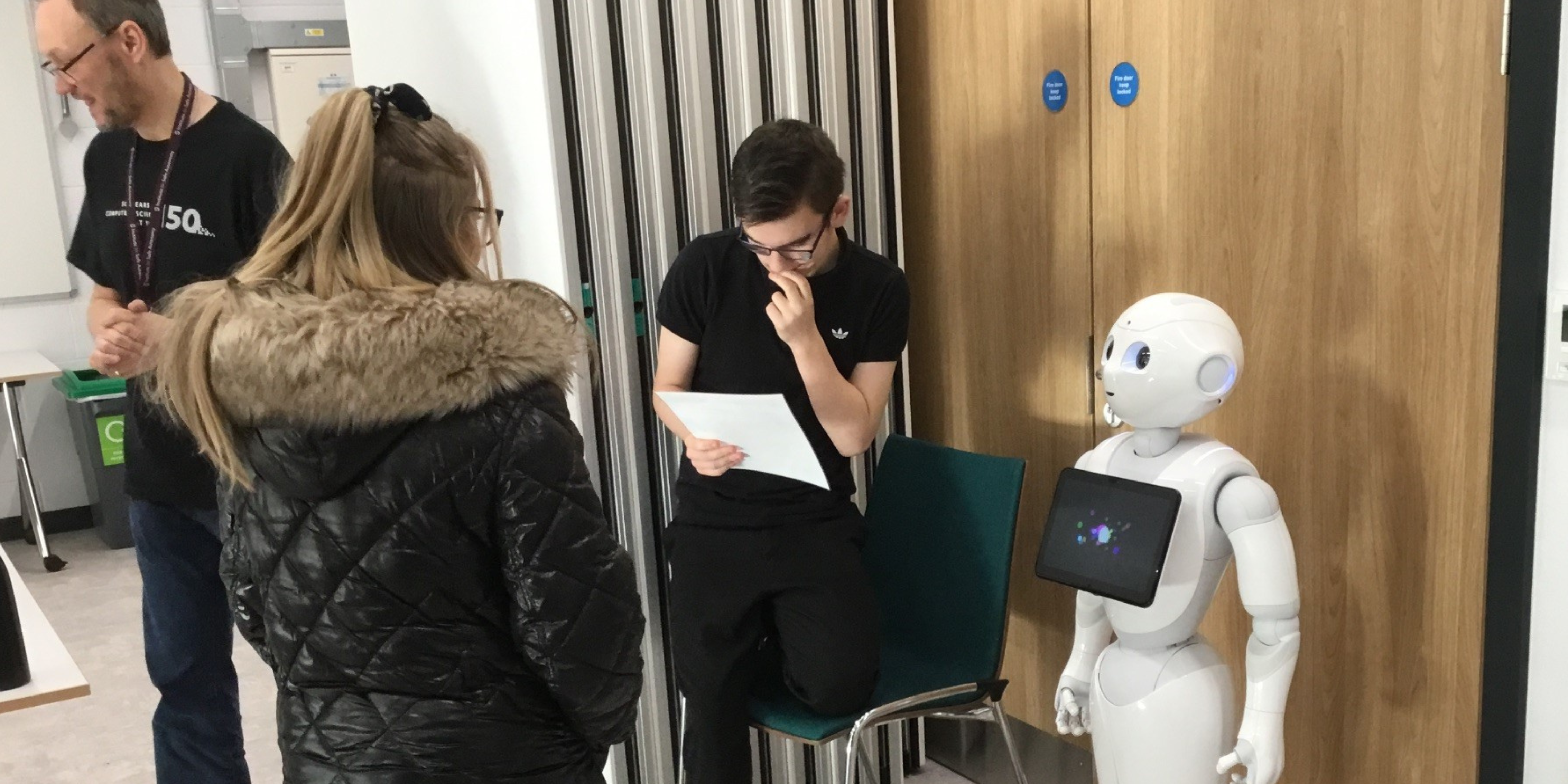 Young people, researchers, and a humanoid robot